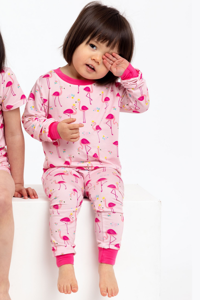 Toddler wearing bamboo pyjamas in pink flamingo print
